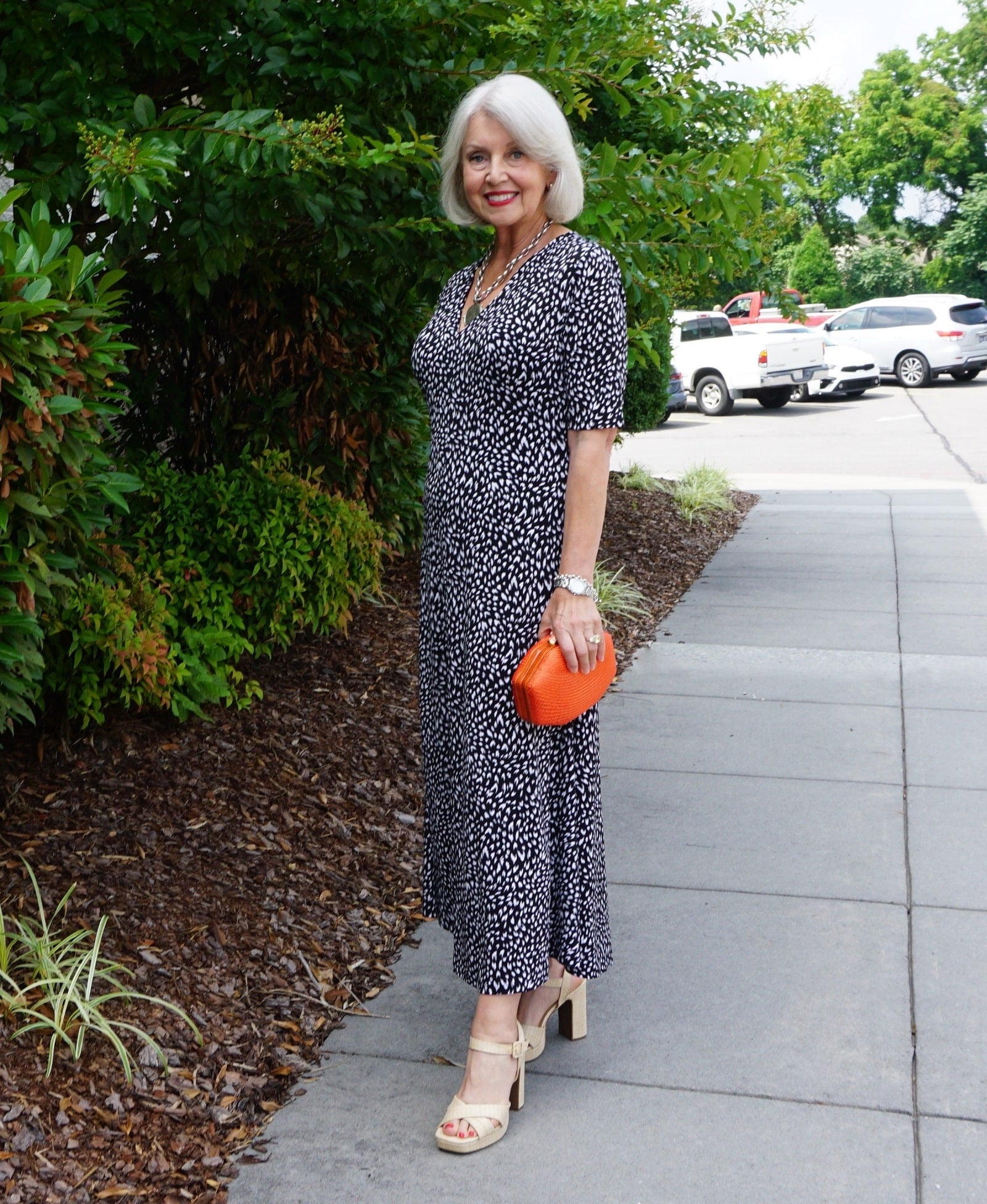 Black and White Printed Midi Dress with Orange Clutch Black and White Printed Midi Dress with Orange Clutch — Dresses for Women Over 60