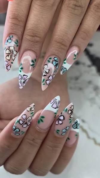 Floral And Leaf Motifs On French Tips Sheer Pink Almond with Floral and Leaf Art — trendy almond nail designs