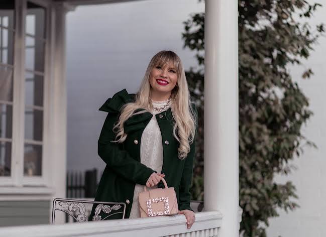 Camel Coat Over White Turtleneck with Plaid Mini Skirt — Green Christmas Outfits 2026