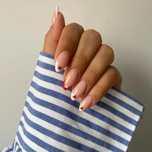 Glossy Nude Almond French Tips with Heart Tips Glossy Nude Almond French Tips with Heart Tips — Mismatched Heart Nails 2027