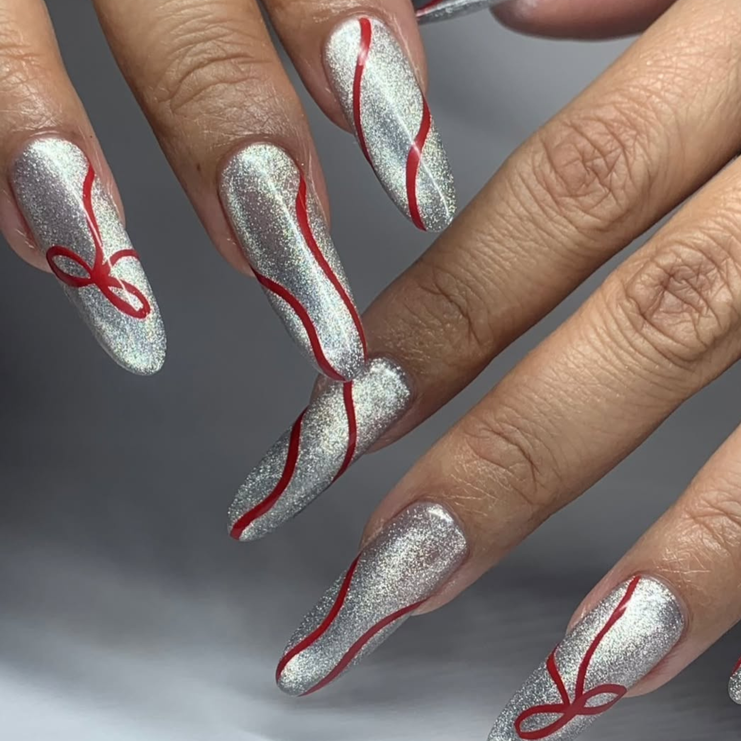 Silver Glitter Cat Eye with Red Accents Silver Glitter Cat Eye with Red Accents — Winter Cat Eye Nails